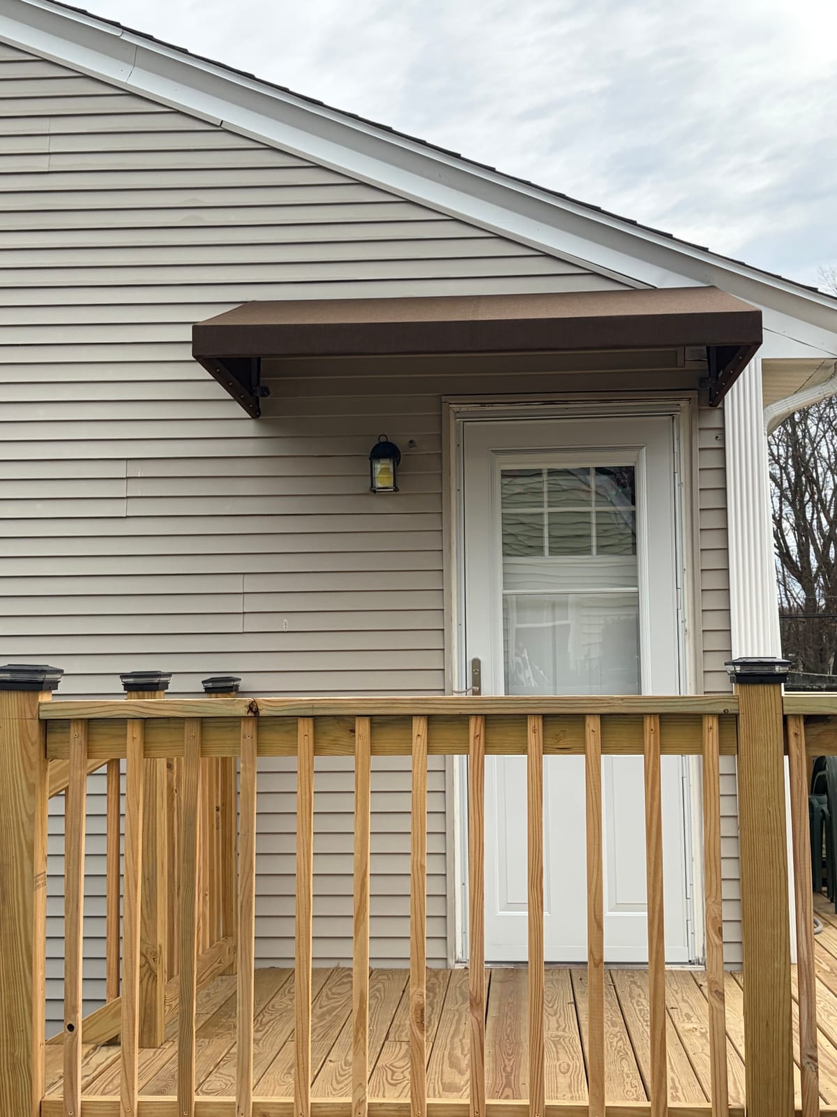Brown door awning over a rear deck door