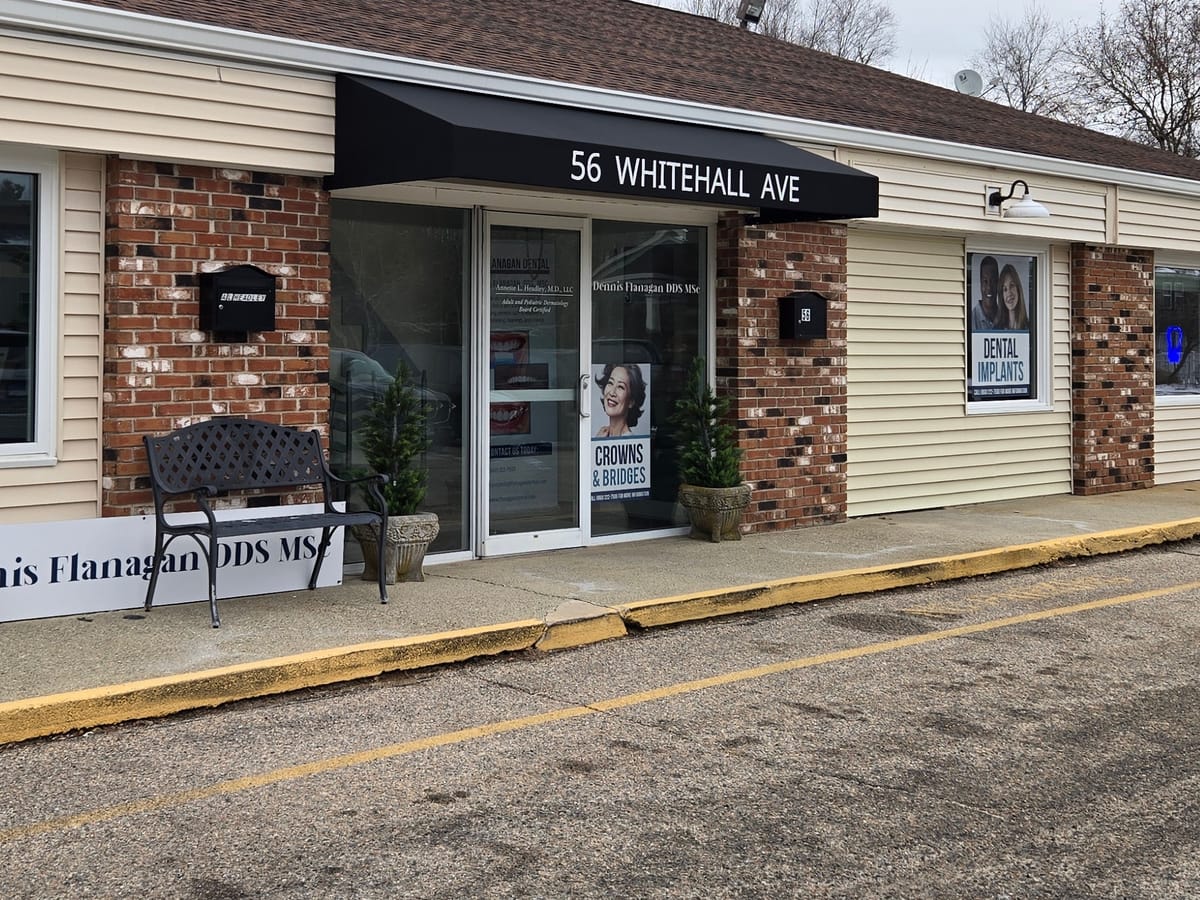 Black door canopy with white address lettering at an office entry