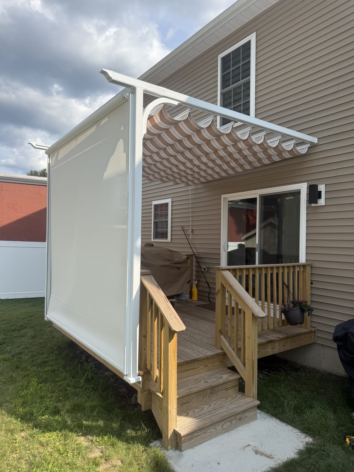 Slide-wire canopy pergola with privacy screen down