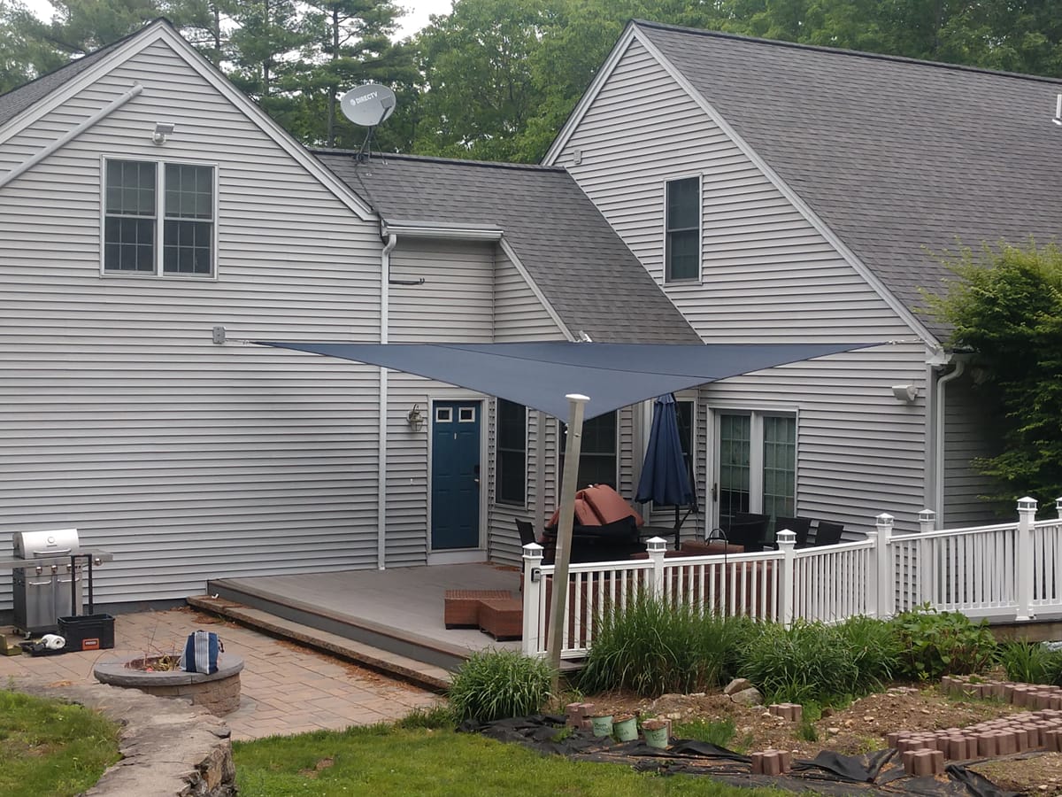 Blue shade sail over residential patio deck