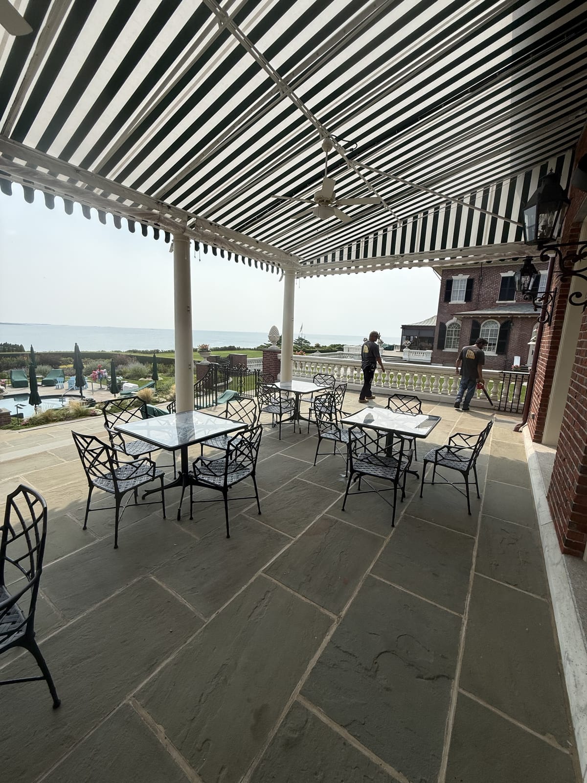 Under the striped patio canopy with ocean view — Newport home