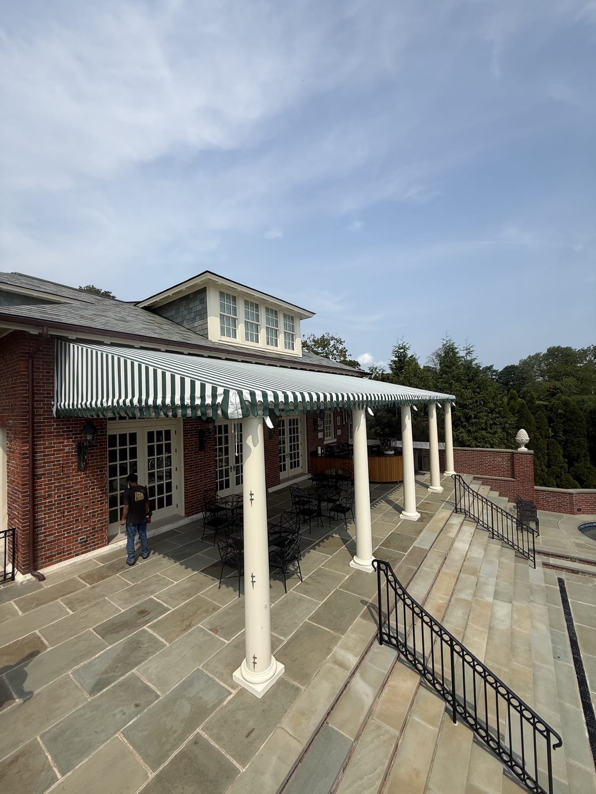 Striped stationary patio canopy on columns — Newport home