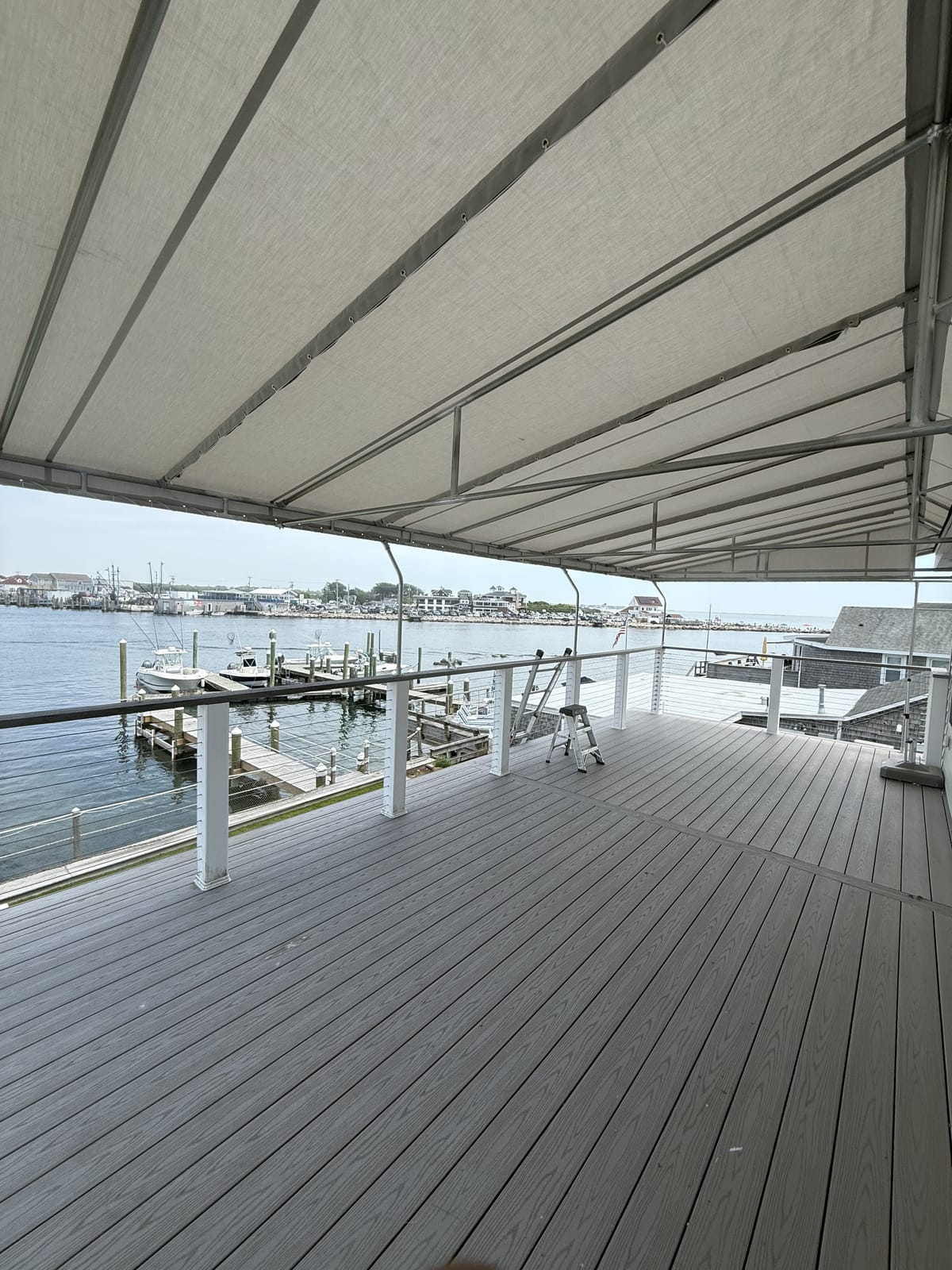 Stationary canopy over a waterfront deck overlooking the marina