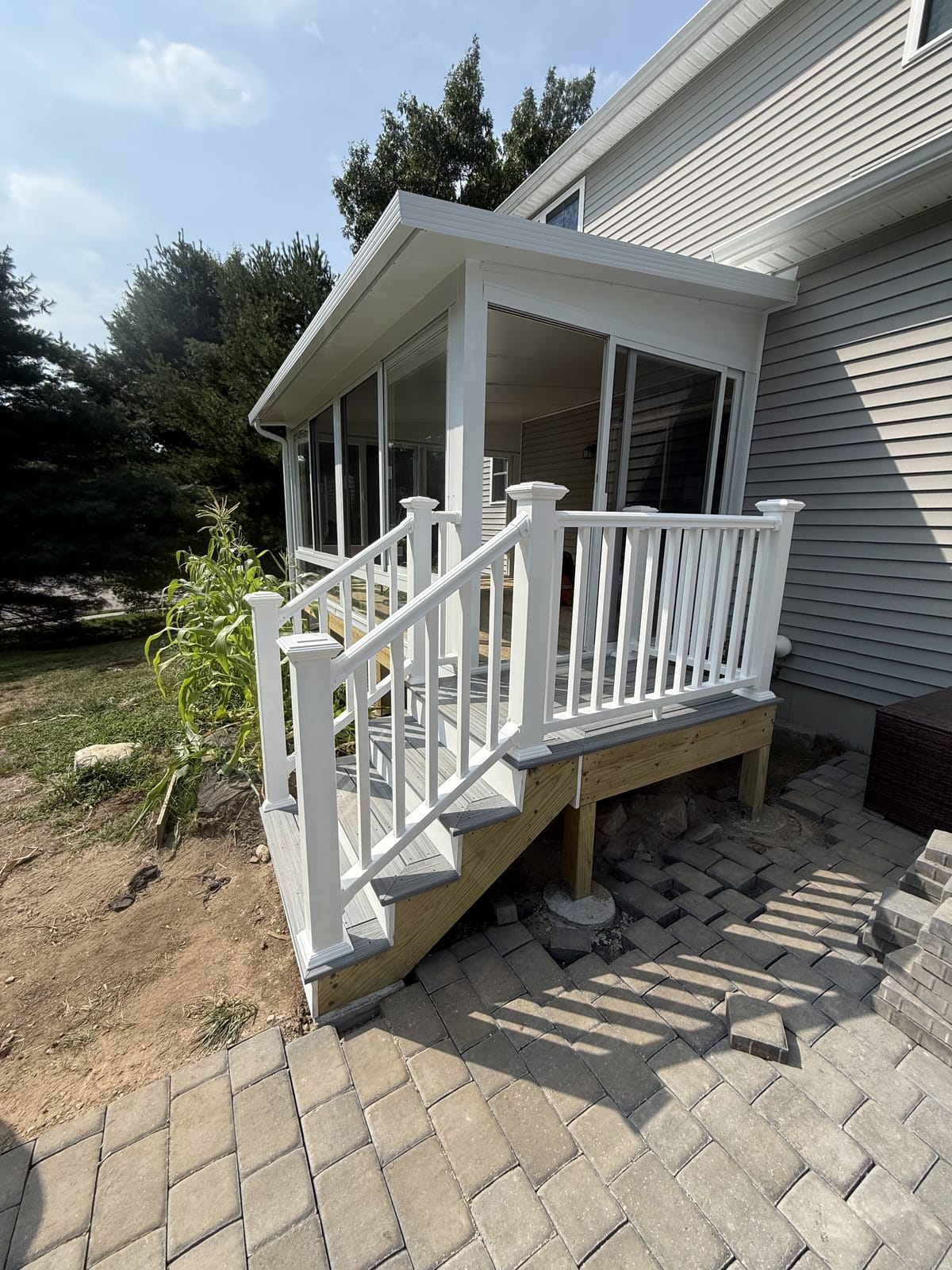 Three-season sunroom with new deck steps and railing