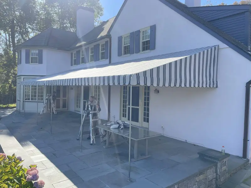 Stationary deck awning on a colonial home