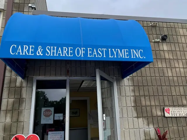Blue curved awning with white lettering over a community organization's door