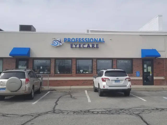 Blue shed-style door awnings over the entrance and windows of a brick storefront