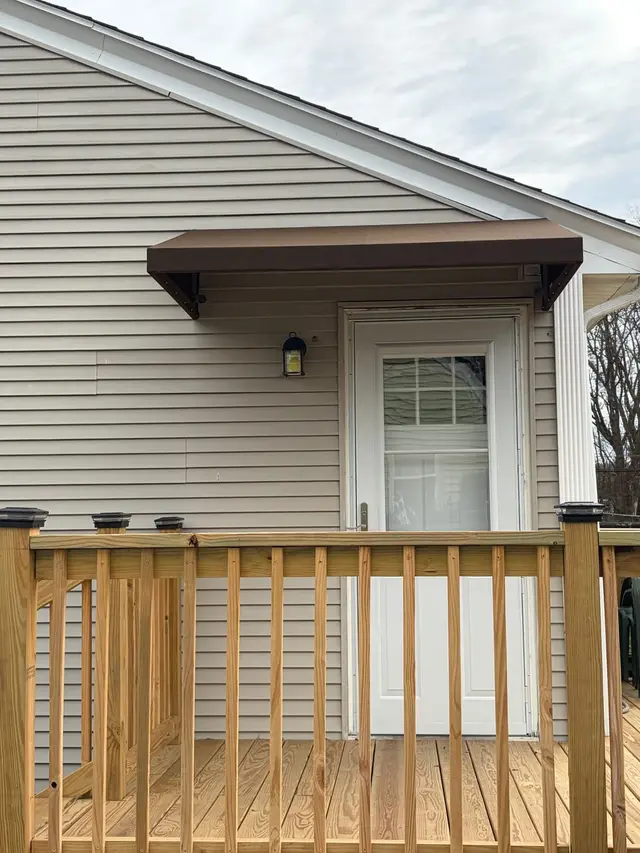 Brown door awning over a rear deck door