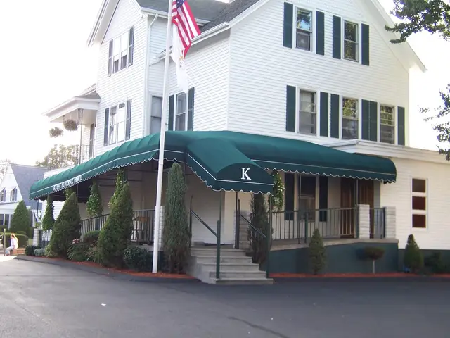 Green wraparound entrance canopy with scalloped valance at Keefe Funeral Home