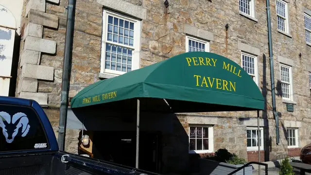 Green dome entrance awning with gold lettering at Perry Mill Tavern in Newport, RI
