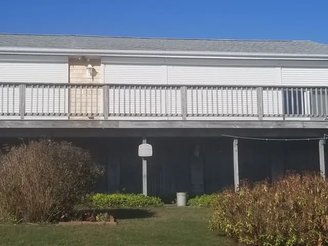 Roll-down hurricane shutters closed along the deck of a Matunuck oceanfront home