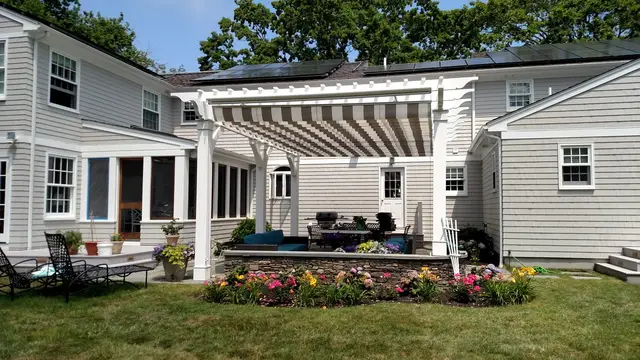 Pergola with retractable canopy over a stone patio in Newport, RI