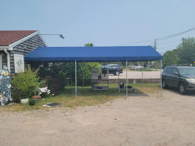 Free-standing A-frame canopy sheltering a farm-stand pickup area