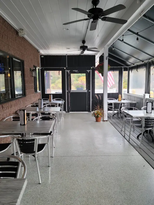 Inside the curtain-enclosed dining patio at Town Grill & Pizzeria