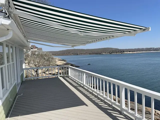 Retractable awning on waterfront home