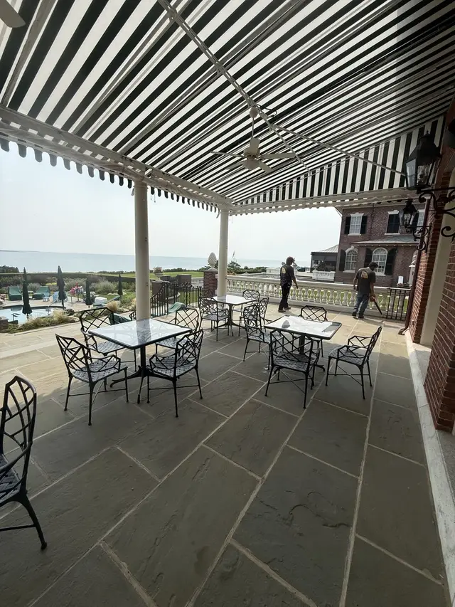 Under the striped patio canopy with ocean view — Newport home