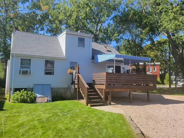 Blue striped stationary canopy over the elevated rear deck