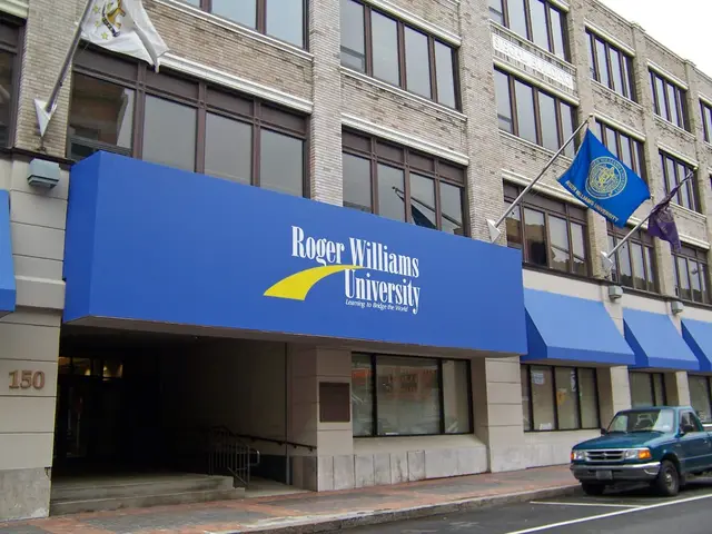 Blue storefront awnings with Roger Williams University branding on the downtown Providence campus