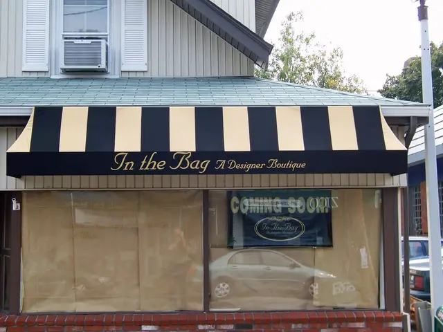 Black-and-tan striped storefront awning with script lettering at In the Bag boutique