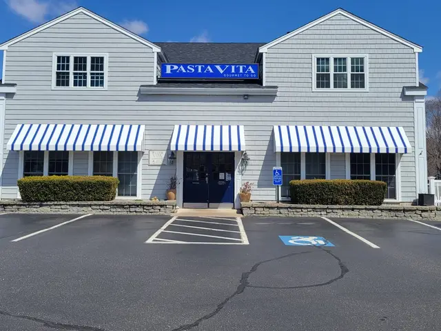 Blue and white striped storefront awnings across the front of a gourmet market