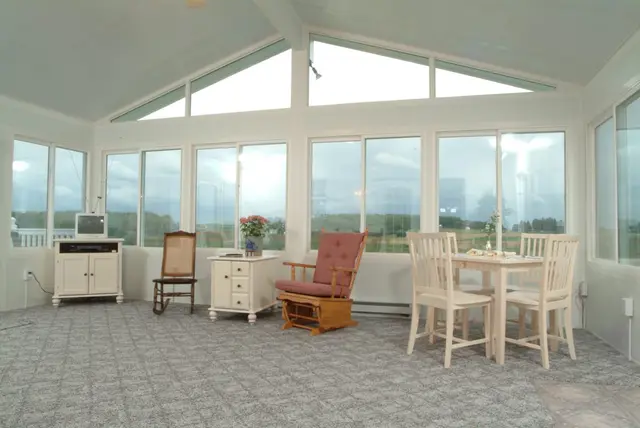 Bright gable sunroom interior with dining set
