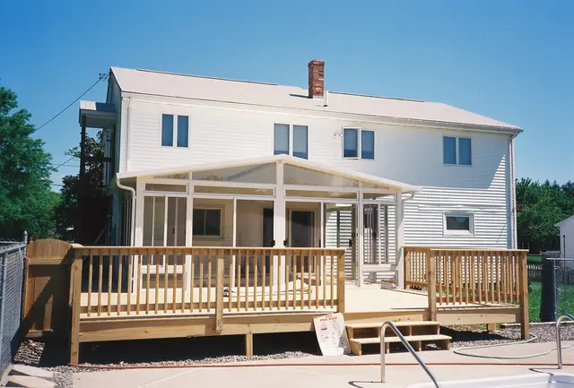 Sunroom and pool deck on a white colonial
