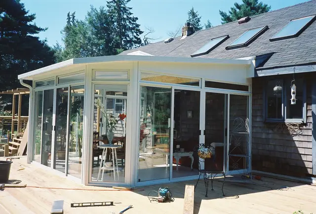 Glass solarium mid-installation by the Pease crew