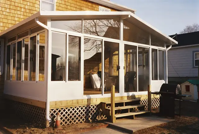 Gable sunroom on a cedar-shingled home