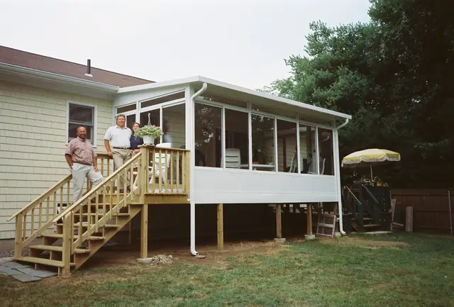 On the steps of a freshly finished sunroom addition