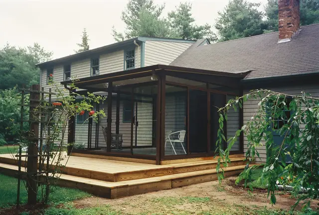 Bronze-frame sunroom on a raised deck