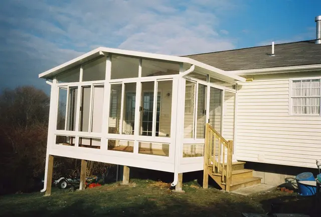 White gable sunroom with entry steps