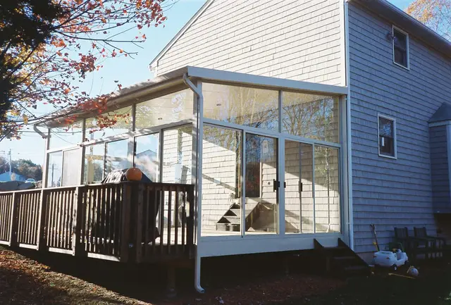 Angled glass patio room on a rear deck