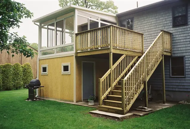 Patio room beneath a deck with exterior staircase