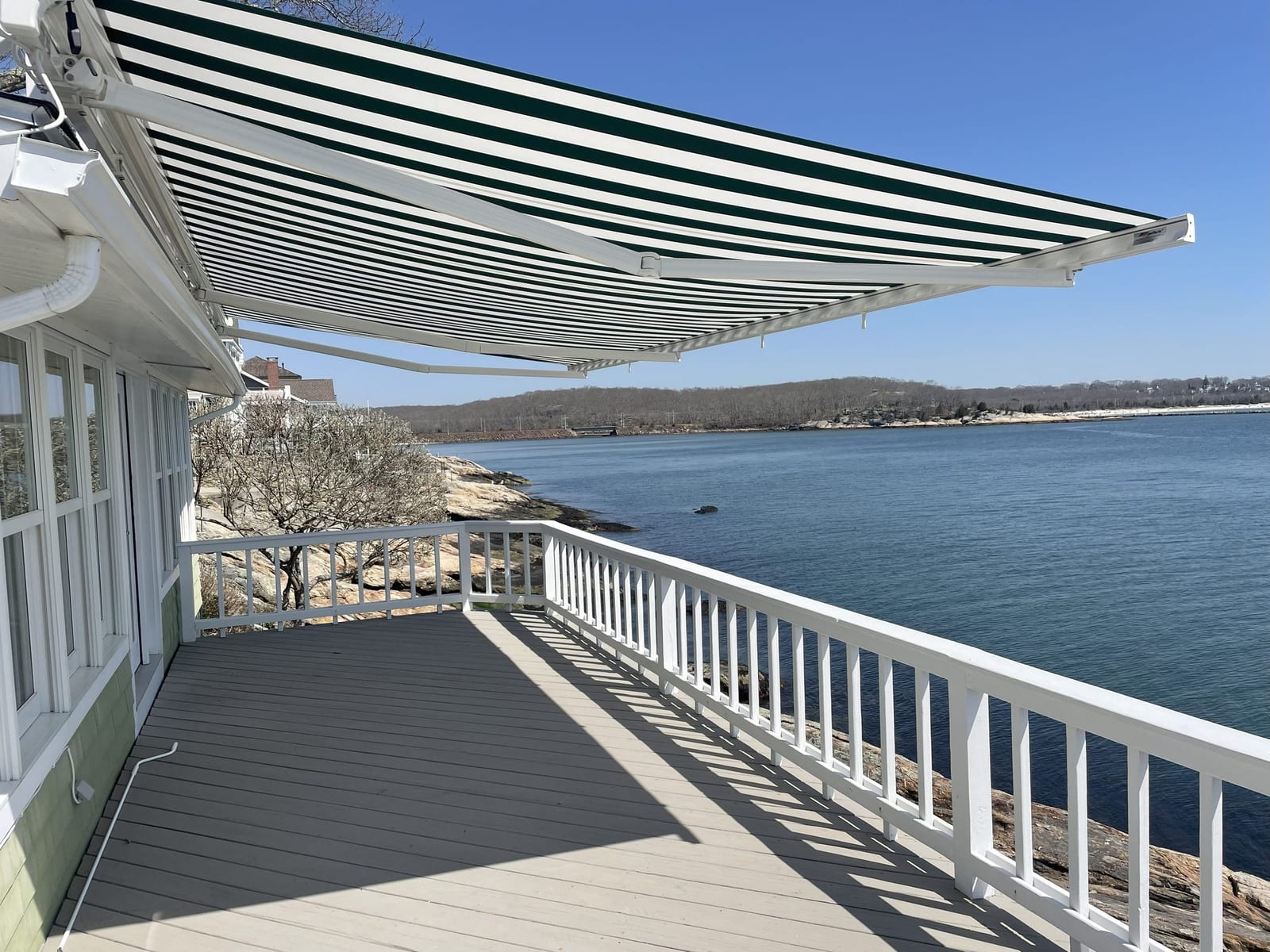 Retractable awning on waterfront home